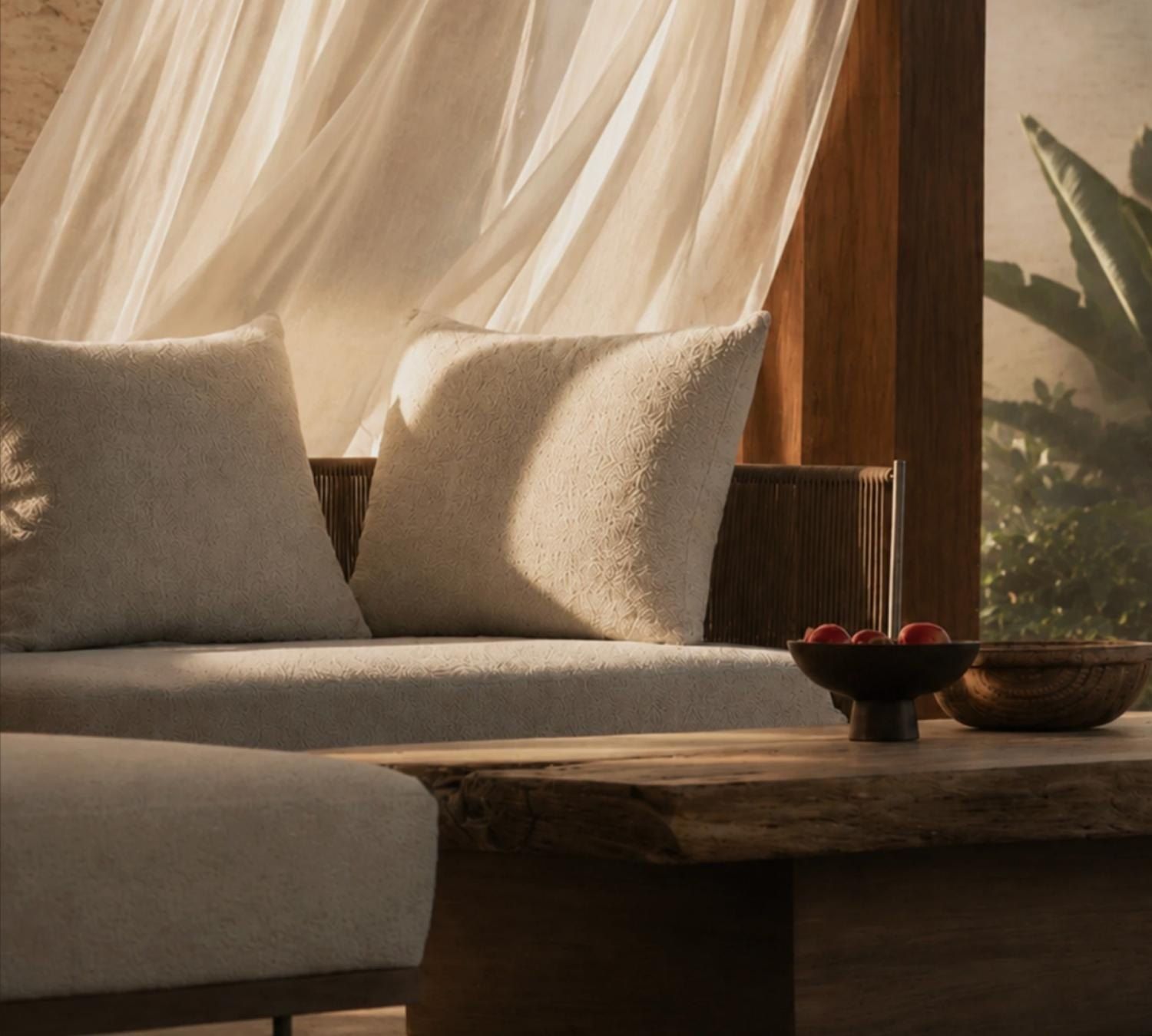 A villa interior opening onto golden-hour island light